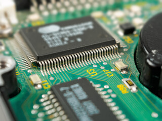 Close-up of ICs, chips, diodes and capacitors on a printed circuit board showing electronic...