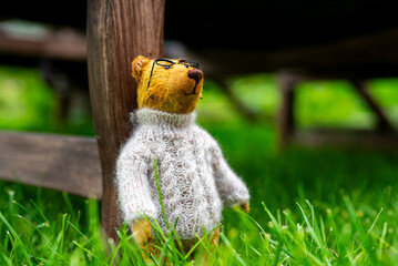 Handmade craft bear in sweater. Children's toy.