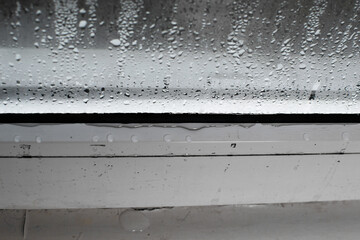 a wet window. high humidity in the air.