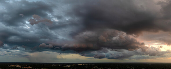 Heavy rain falling down from stormy clouds during thunderstorm on dark sky. Moving and changing...