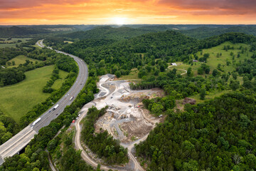 Industrial open-pit mining site with limestone quarry at mountain hillside
