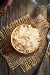 Fermented cabbage or sauerkraut in a brown pot