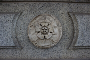 part of the decor, in the form of a flower, made of concrete. Antique building.