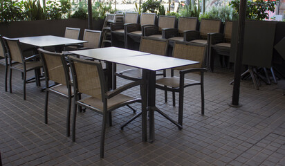 interior of a street cafe with table and chairs.