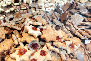 Colorful assortment of star-shaped cookies at a festive market during the holiday christmas season