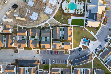 Wooden houses under construction in new developing suburban area. Development of residential...