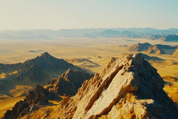 Aerial view of a mountain range with rolling hills and peaks, suitable for use in travel or outdoor adventure visuals