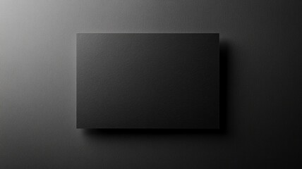 Blank black rectangular card on dark surface, minimalistic design