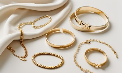 Simple Jewelry Flat Lay with gold bracelets on a plain white fabric background