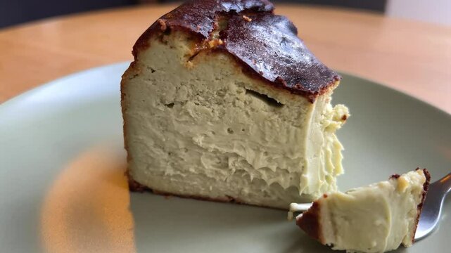 cut off a piece with a fork Barsky pistachio cheesecake Tasty green pistachio cheesecake slice circle rotation close up