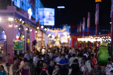 Blur defocus Crowd people in Christmas festival market mall event time celebrations and  Christmas tree with decoration ball and light bulb on