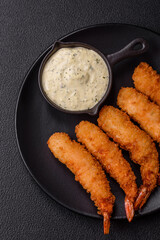 Hot crispy shrimp breaded with salt and spices with white sauce