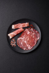 Antipasto jamon, prosciutto, sausage, sliced with tomatoes, salt and spices