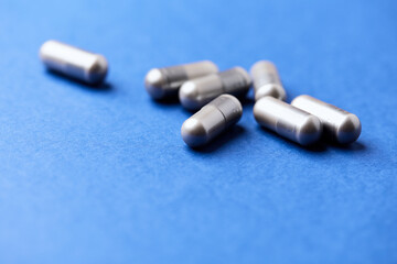 BCAA amino acids capsules. Nutrition for bodybuilding. Fitness supplements on paper background. Soft focus. Copy space