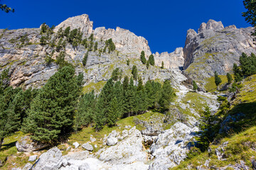 Sunny day in the Dolomites. Rocky mountain peaks of Dolomiti Alps in summer under the blue sky with...