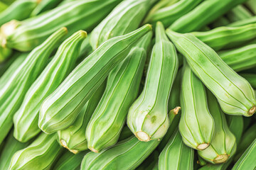 Obraz premium Fresh Okra Pods on a White Background