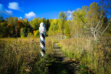 Wooden Trail with Border Marker in Wetlands
