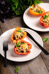 Stuffed peppers with herbs and cheese on the rustic background. Selective focus. Shallow depth of field.