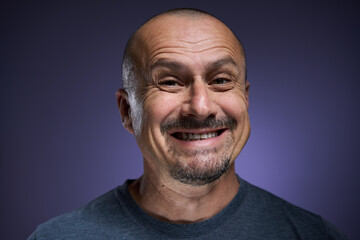 Happy mature man on purple background