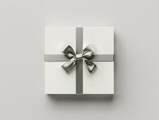 White gift box with silky silver ribbon bow isolated on white background