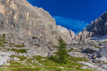 Sunny day in the Dolomites. Rocky mountain peaks of Dolomiti Alps in summer under the blue sky with...