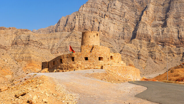 historic stone fort in Bukha, Musandam, Oman, against the backdrop of mountains. Al Qalaa Fort