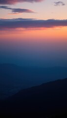 a mountain with a sunset in the background