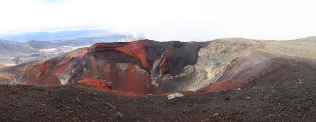 Panorama of the Red Crater on the Tongariro Alpine Crossing in the Tongariro National Park, New Zealand. The iconic geological vertical dyke and basalt scoria features are visible from the front.