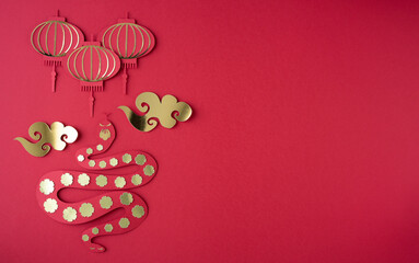 Figure of a snake with clouds and lanterns on a red background. Chinese New Year. Year of the snake. Copy space