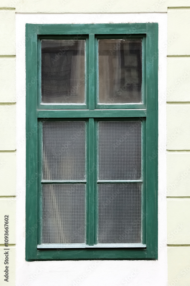 Poster view of building with green window