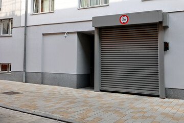 View of building with big window and roller shutters