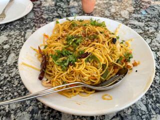 Noodles served in a plate, also known as chowmein.