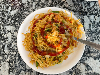 Noodles served in a plate, also known as chowmein.
