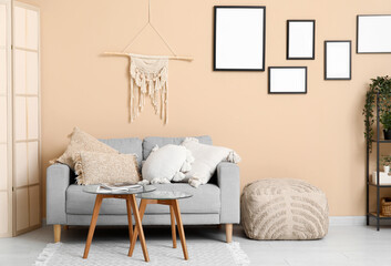 Cozy sofa, coffee table and pouf in living room