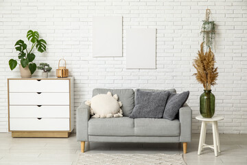 Cozy sofa and chest of drawers in interior of living room