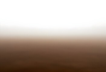 Obraz premium A vast, dusty landscape shrouded in a hazy, brown fog, with the horizon barely visible