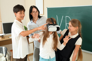 Teenage girl using VR glasses with her classmates and teacher at school