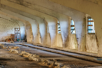 An abandoned destroyed barn, cowshed, warehouse or hangar from the inside. An old abandoned...