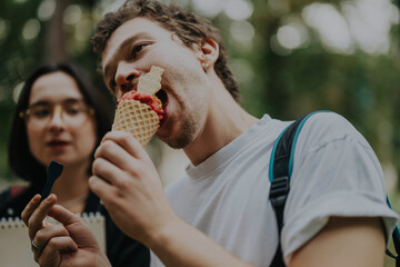 Group of college students savoring ice cream with their professor in a relaxed outdoor setting....