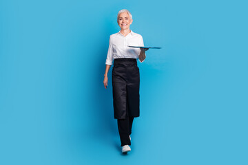 Full body photo of attractive senior woman walk carry tray small business cafe owner dressed...