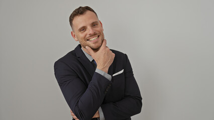 Cheerful young man with beard in a suit smiling against a white background