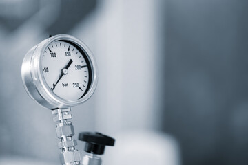 A pressure gauge with a black knob and a white face. The gauge is showing a pressure of 150 PSI