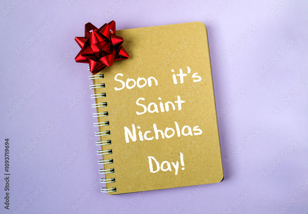 Aufkleber notebook with a red bow on it that says soon it's saint nicholas day