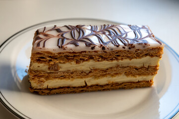 Portion of french mille-feuille cake, vanilla or custard slice, Napoleon puff pastry layered with pastry cream in bakery