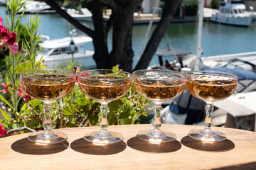 Summer party, French brut rose champagne sparkling wine in coupe glasses in yacht harbour of Port Grimaud near Saint-Tropez, French Riviera vacation, Var, France