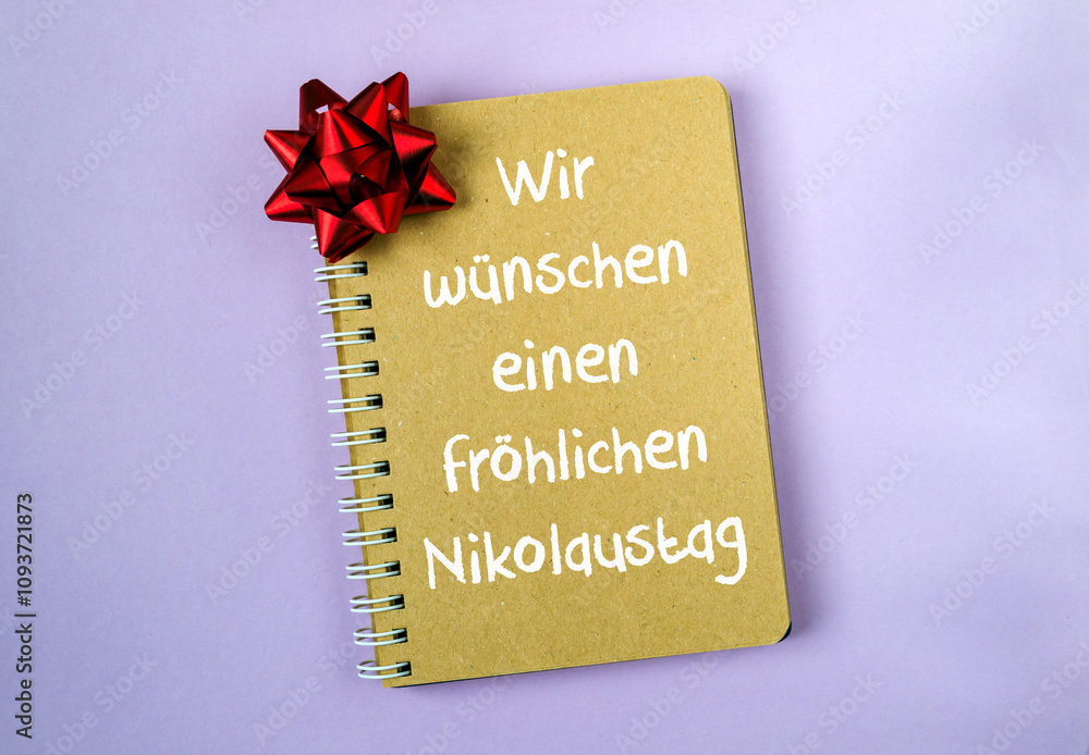 Aufkleber notebook with a red bow on it