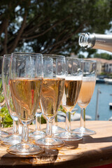 Summer party, French brut rose champagne sparkling wine in flute glasses in yacht harbour of Port Grimaud near Saint-Tropez, French Riviera vacation, Var, France
