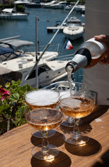 Summer party, French brut rose champagne sparkling wine in coupe glasses in yacht harbour of Port Grimaud near Saint-Tropez, French Riviera vacation, Var, France