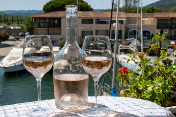 Glasses of cold rose gris Cote de Provence wine in yacht harbour of Port Grimaud, summer vacation on French Riviera in Provence, France