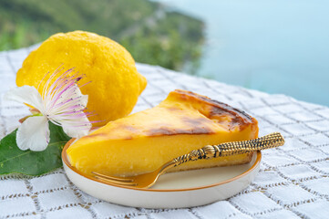 Summer time in Provence, flan dessert with lemon and blue sea view on background, French Riviera...